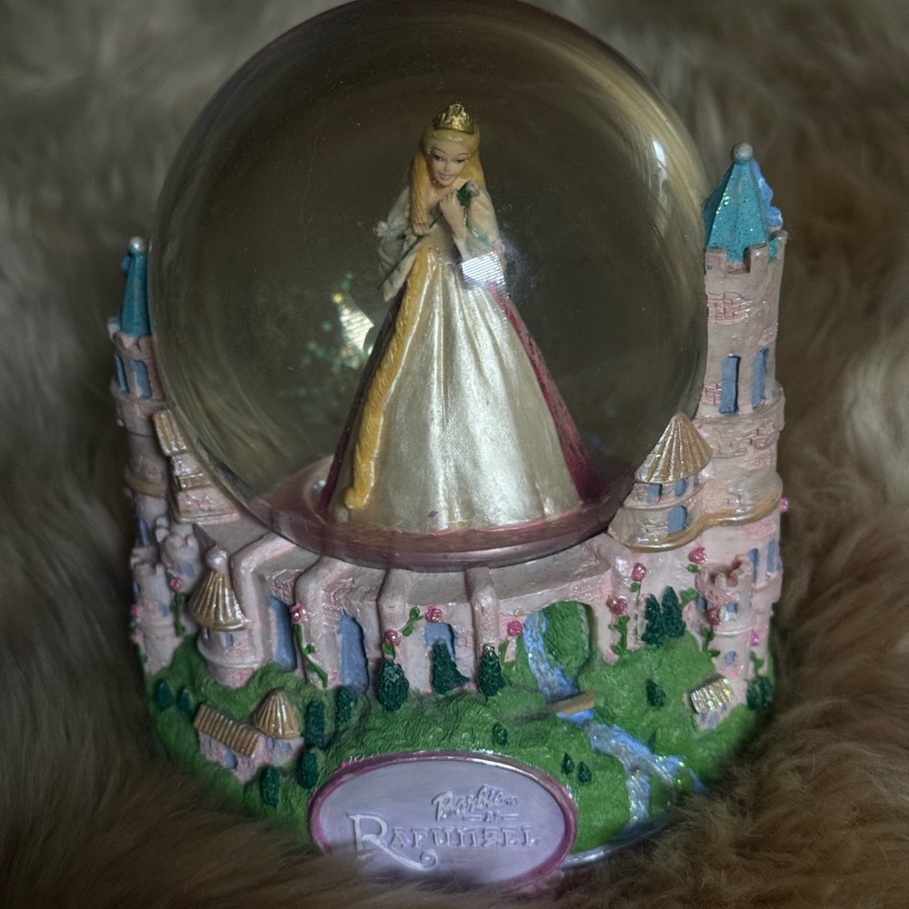 disney rapunzel castle snow globe with gold and pink accents